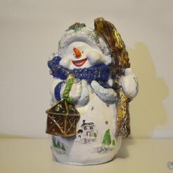 Lumiukko ja luuta patsas, hymyssä suin